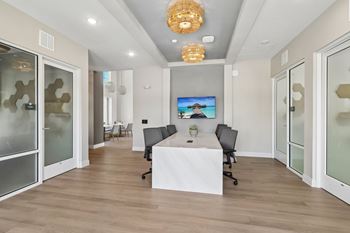 Conference room with mounted screen and office chairs
